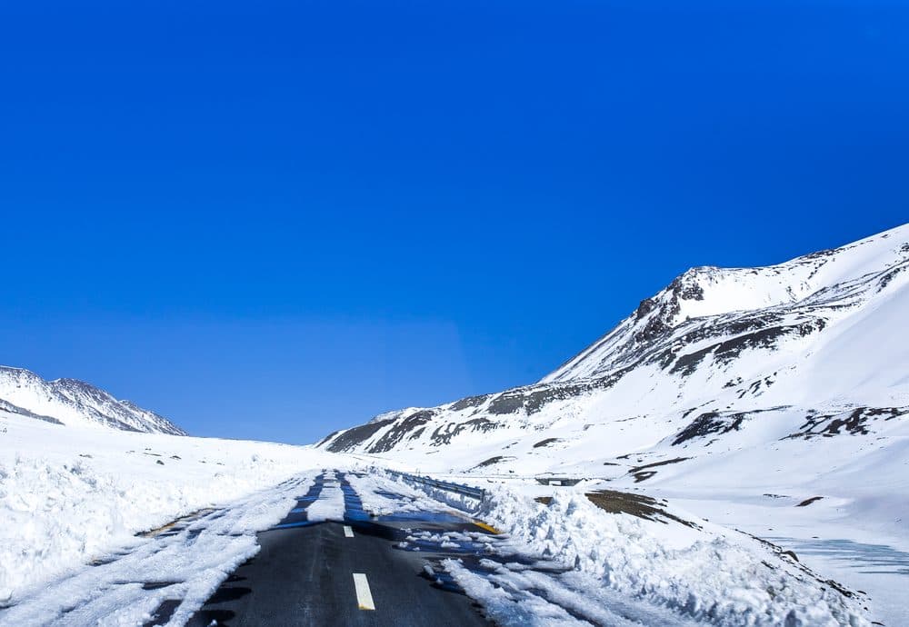 The snow-cleared road climbing towards the Khunjerab plateau in winter