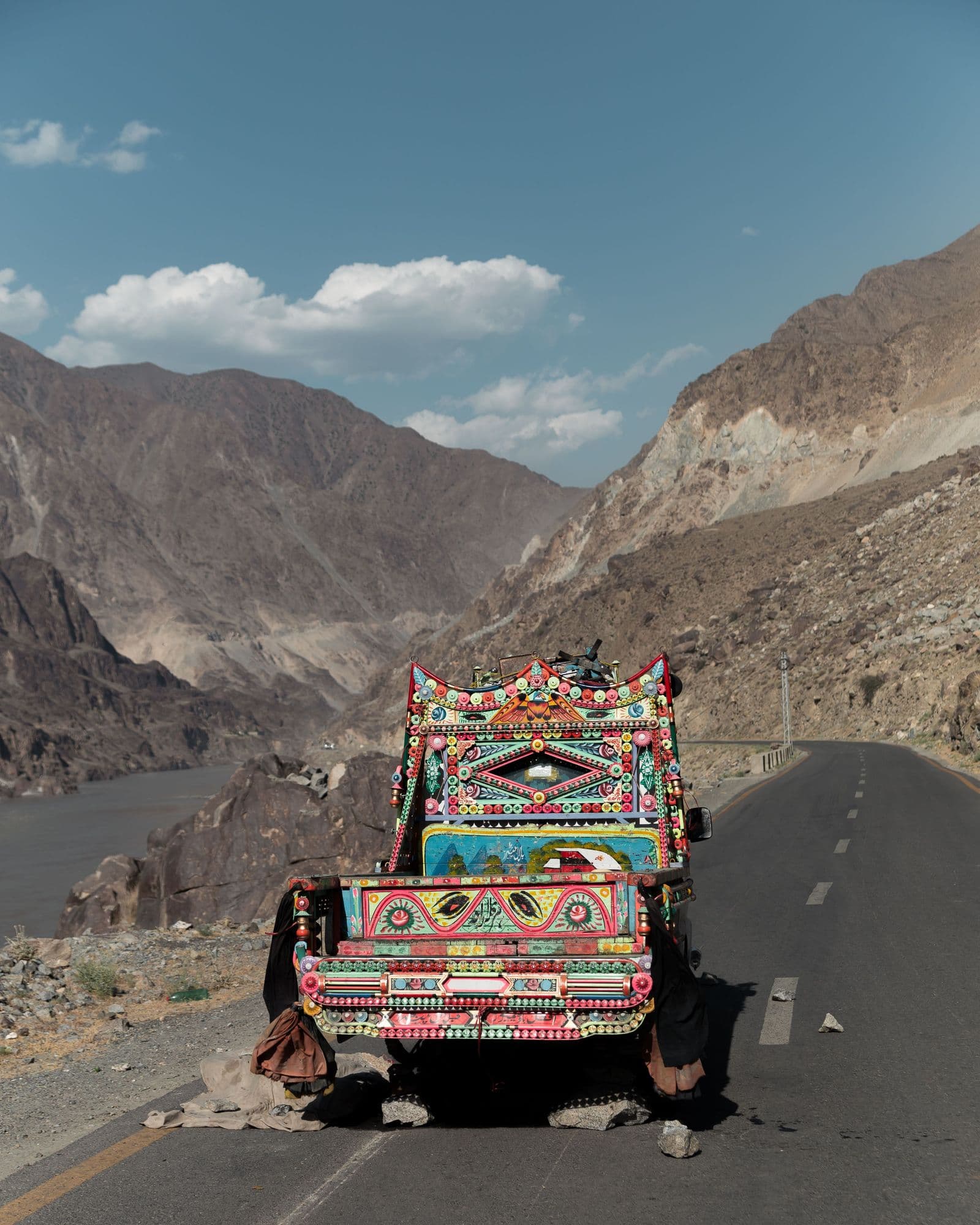 Decorated Pakistani truck on the Karakoram Highway with mountains behind