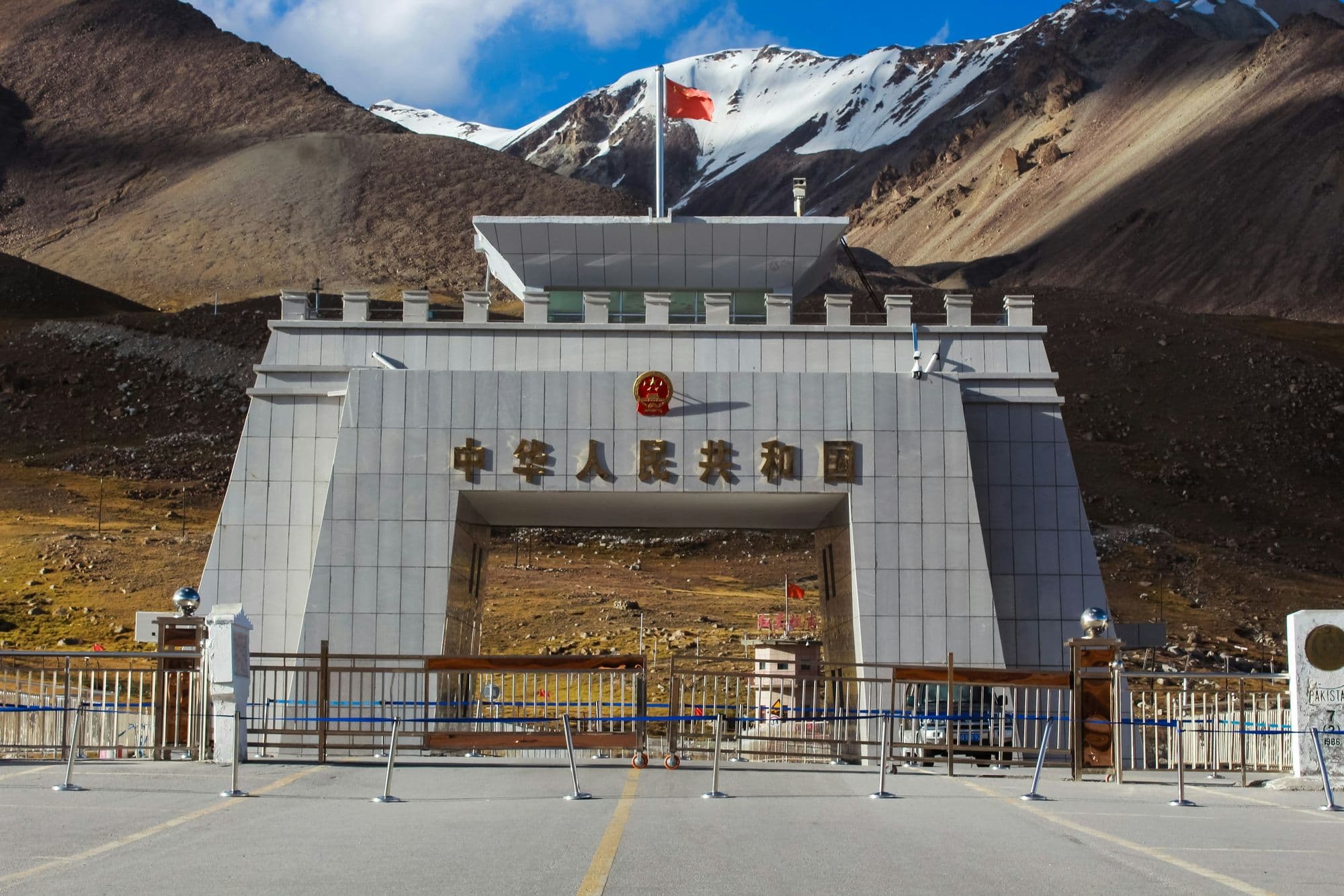 Khunjerab Pass at the Pakistan-China border with the border gate and bare mountains behind