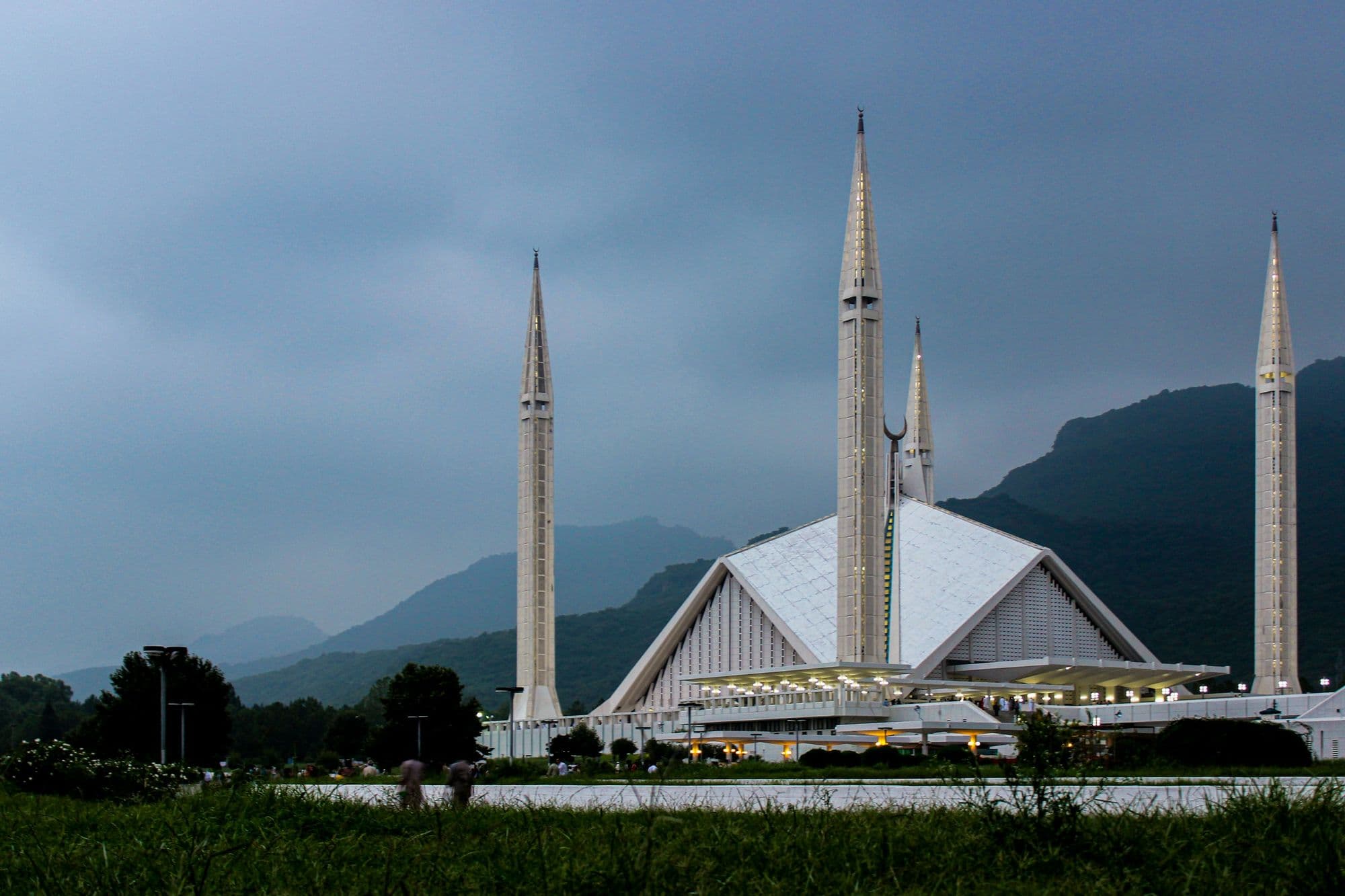 The white Faisal Mosque in Islamabad with its four minarets against the Margalla Hills