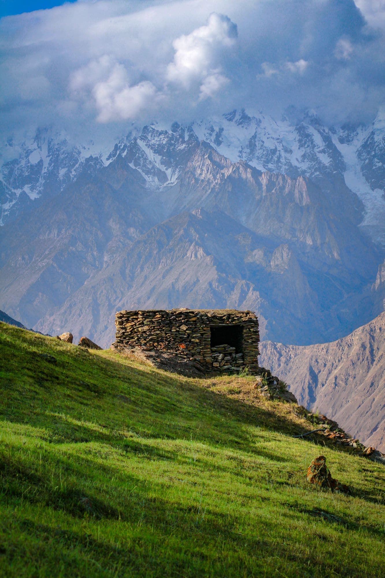 Terraced fields of Hopar village in Nagar valley, Pakistan, beneath steep Karakoram peaks