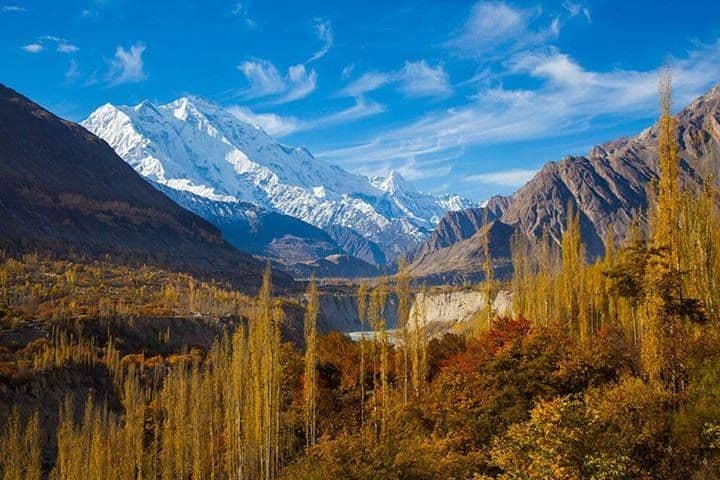 Autumn-tinted terraces and snow peaks along the Karakoram Highway in Gilgit-Baltistan