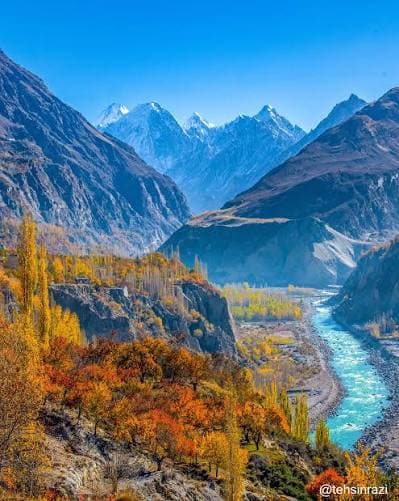 The Hunza river running below autumn-coloured slopes on the Karakoram Highway