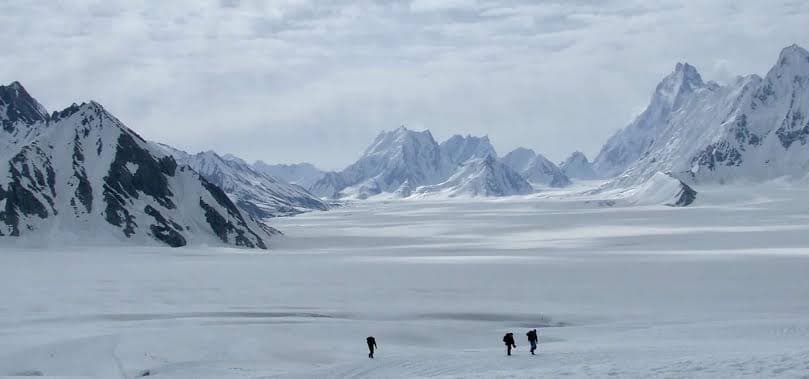 Trekkers crossing the Biafo Glacier on the Biafo Hispar trek in Baltistan