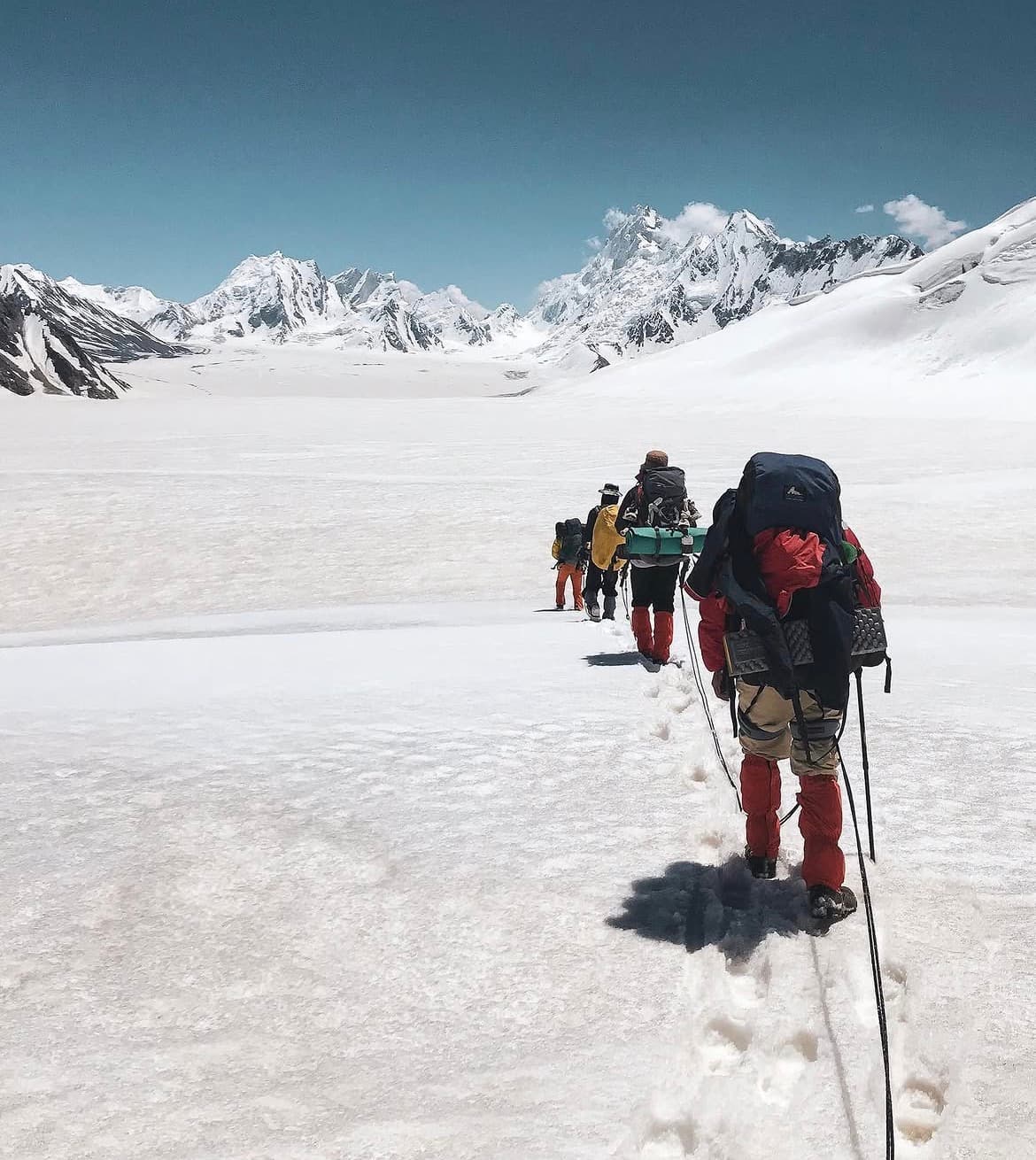Trekkers roped together crossing Snow Lake on the Biafo Hispar trek in Pakistan