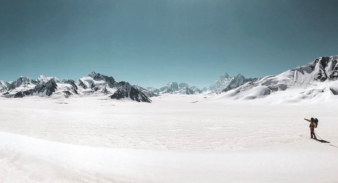 Lone trekker on the Snow Lake trek beneath the peaks that ring Hispar La
